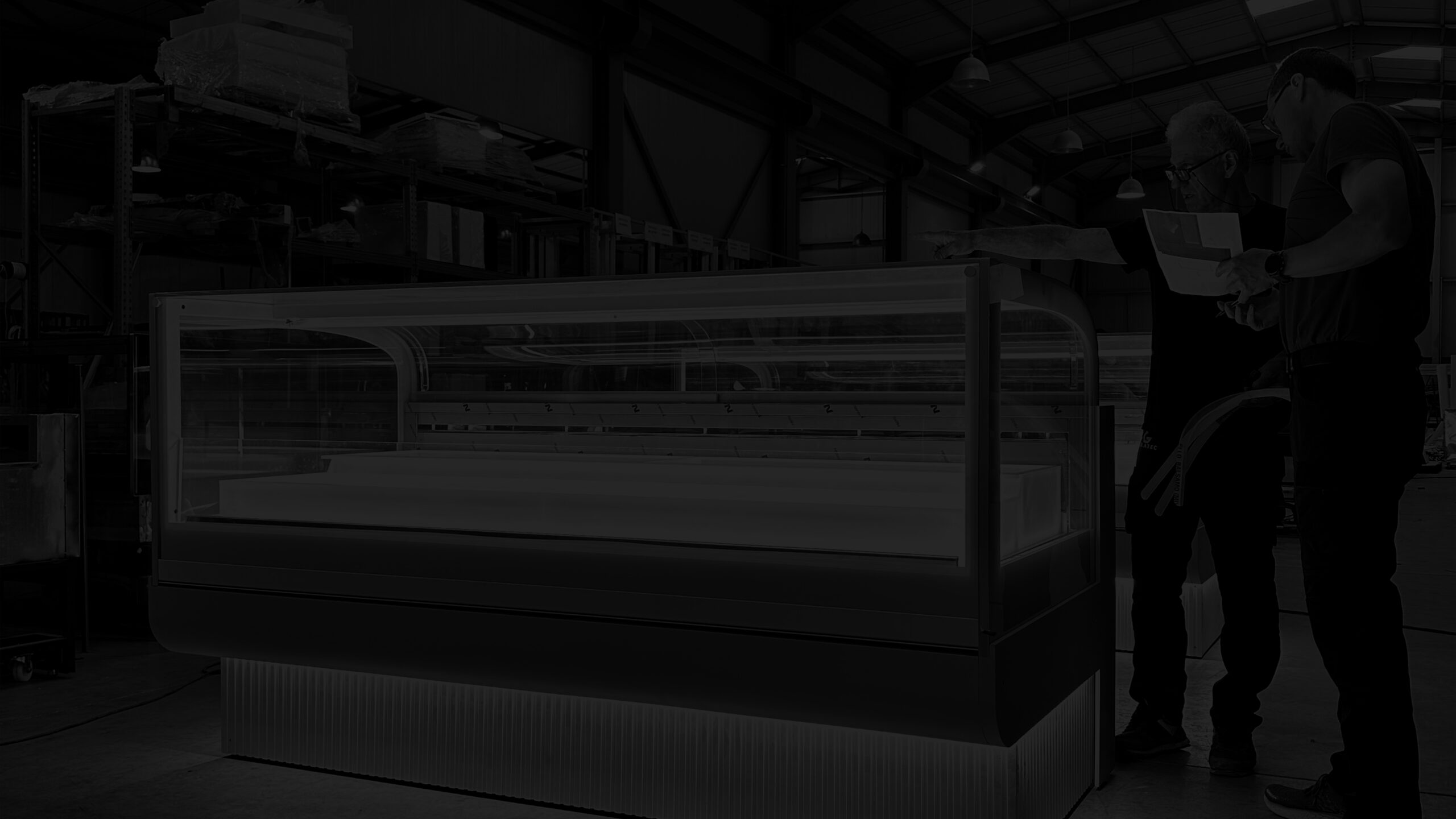 GELATEC team members reviewing a showcase on the production floor